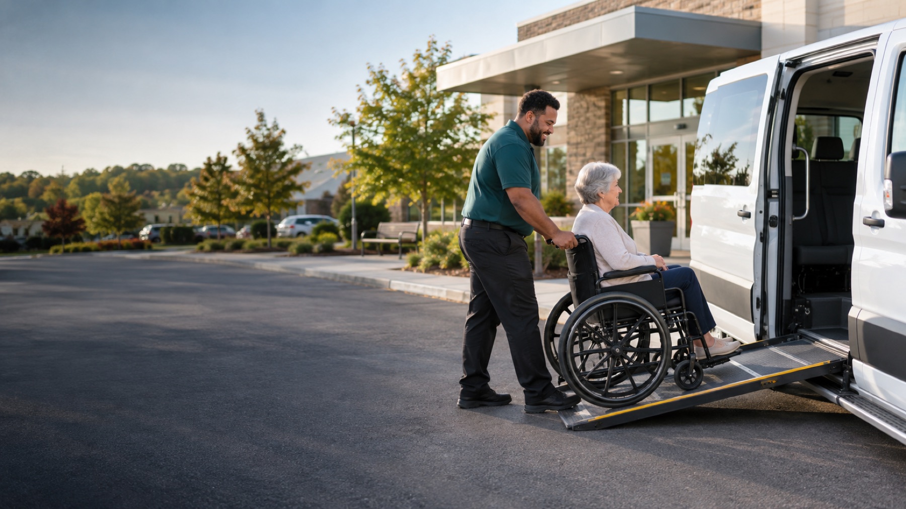 A transportation attendant assisting a wheelchair passenger into an accessible van
